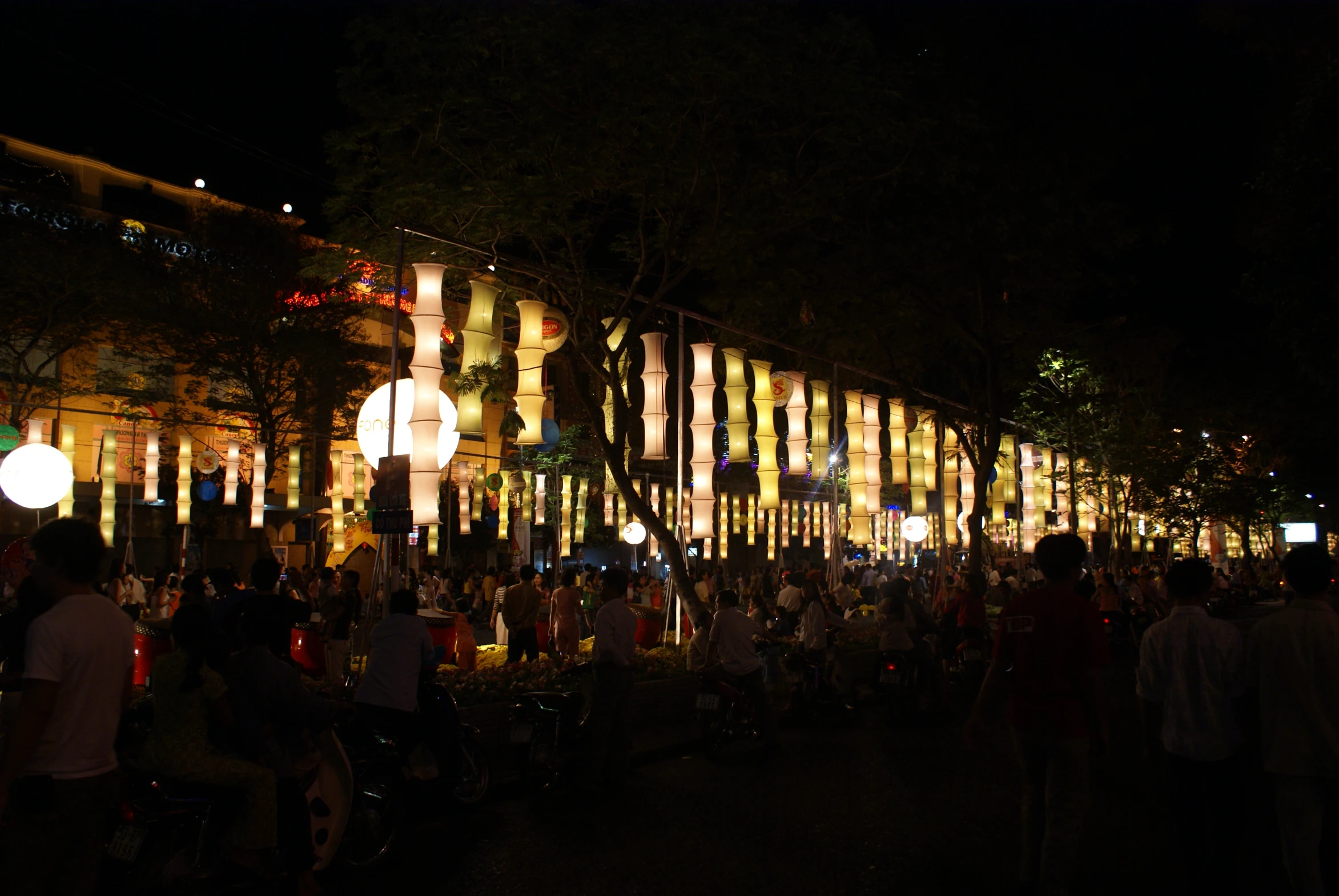 a crowd of people are walking around in a dark area