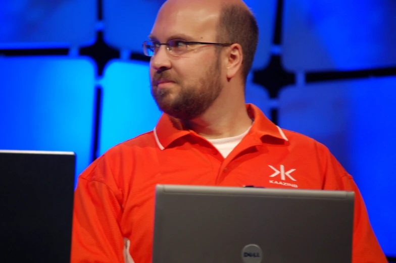 man in front of a monitor at an event