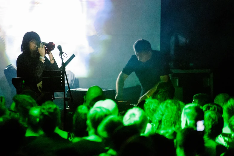 two people on stage playing a musical instrument