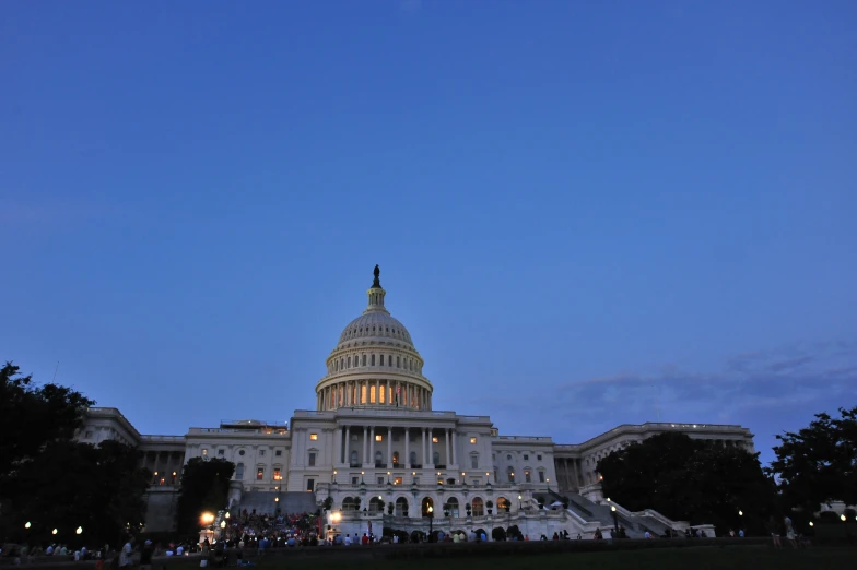 the capitol building lit up at night with its dome illuminated