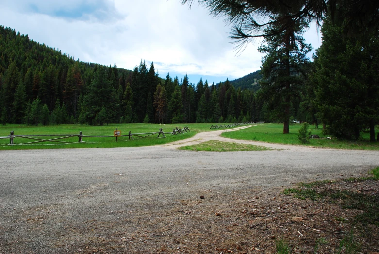 a gravel road in the middle of the countryside