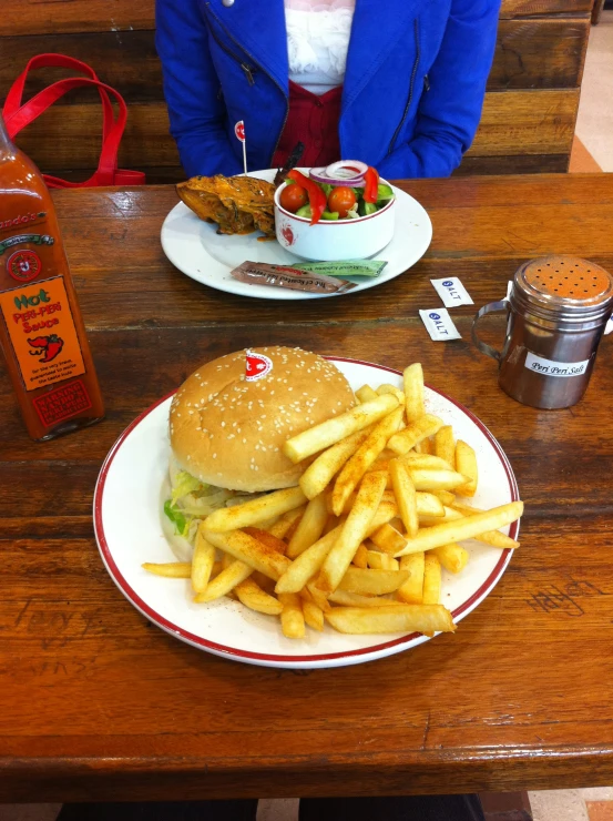 a table that has some fries and a burger on it