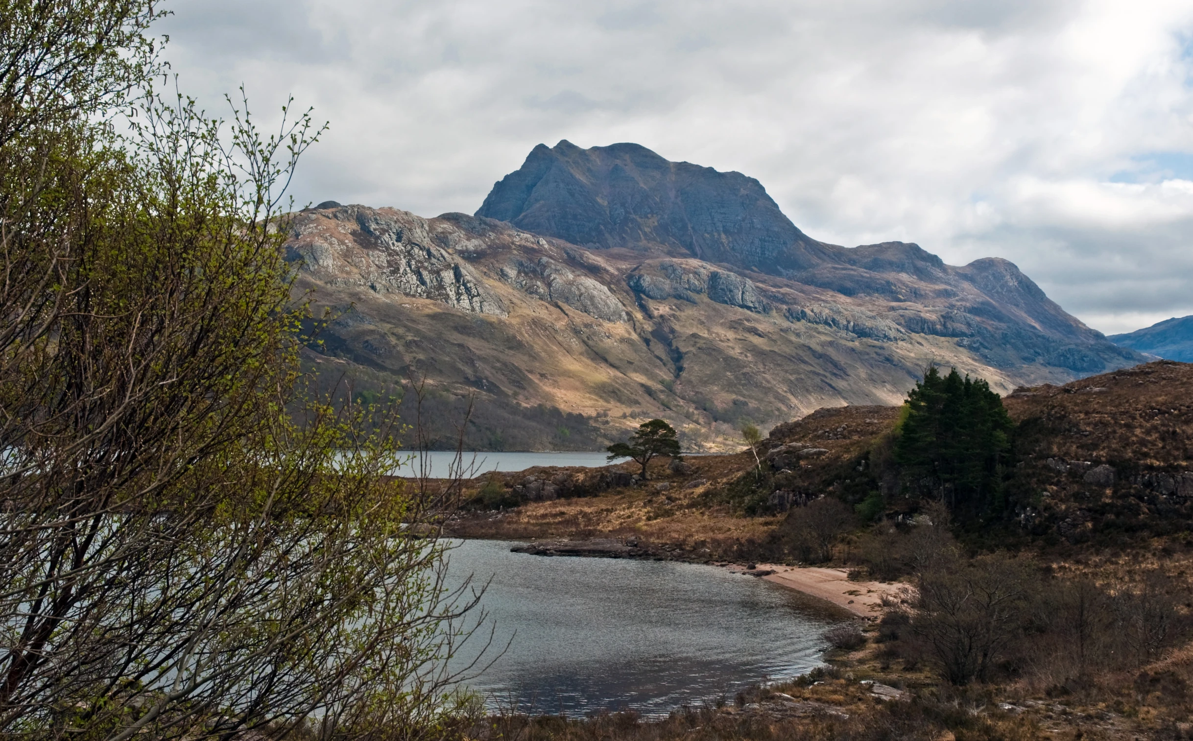 a mountain view with a lake below