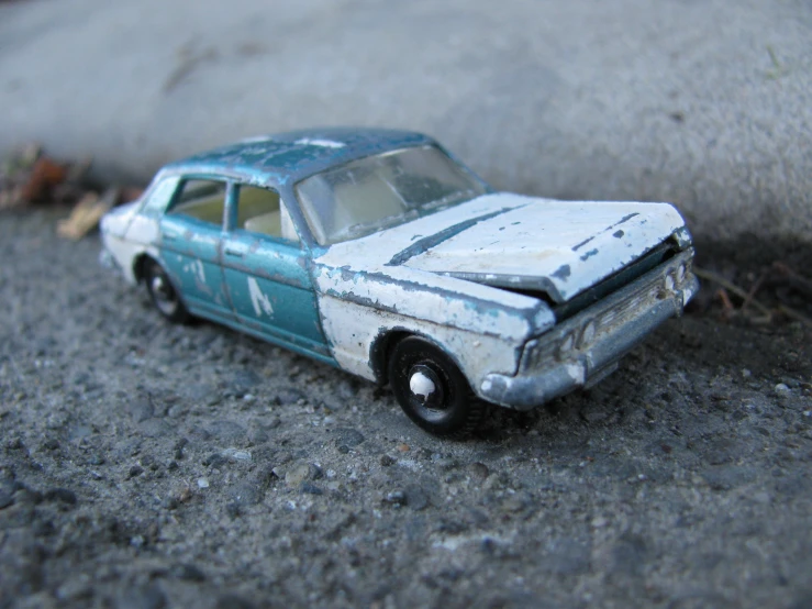 a toy car sitting on the side of a road