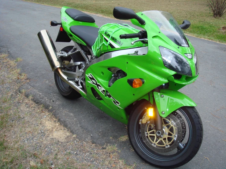 a green motorcycle parked on a street