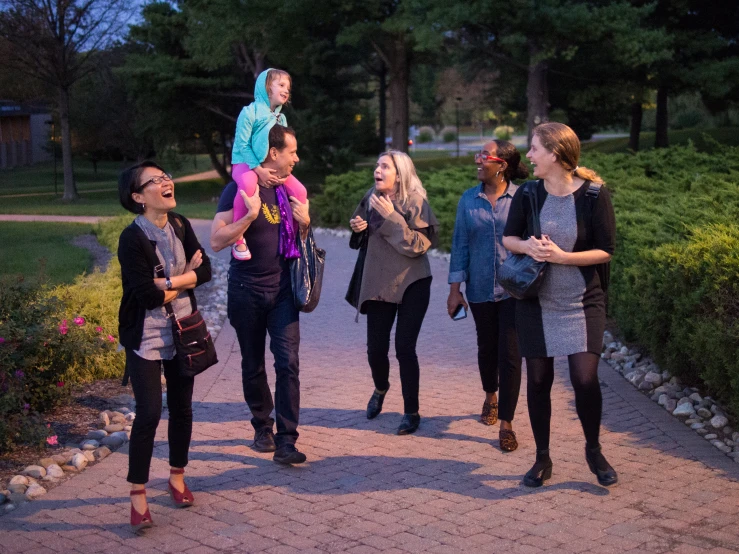 a group of people are walking down a path