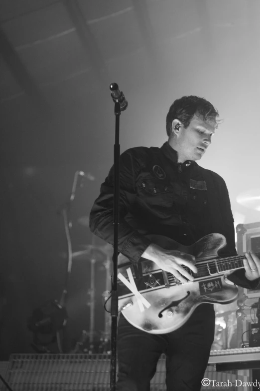 a man playing a guitar and a microphone