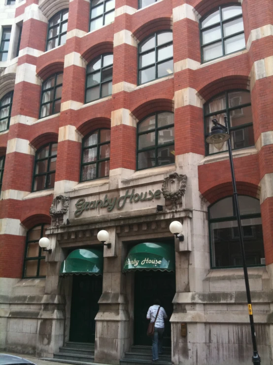 a very large red brick building with an old clock