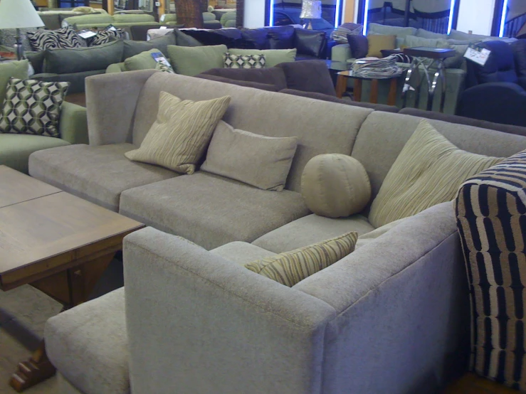 a living room with couches, tables and lamps