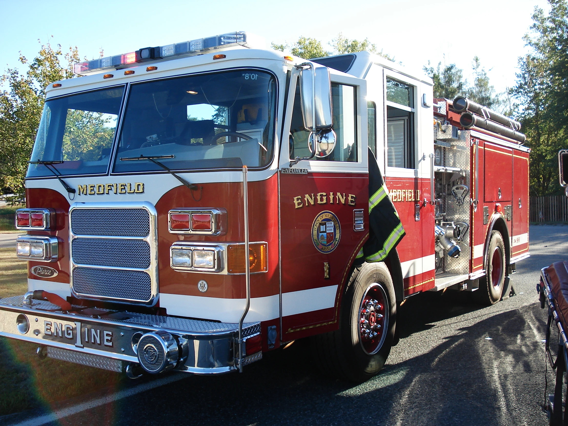 fire truck with ladder extended on the side on street