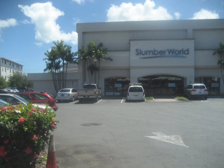 the exterior of a summer world store with parking spaces