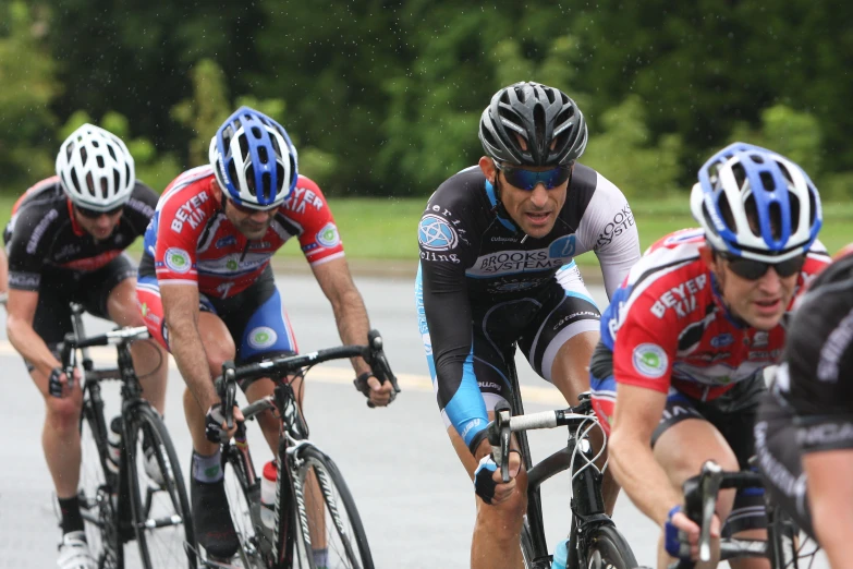 group of men racing on bike bikes on the street