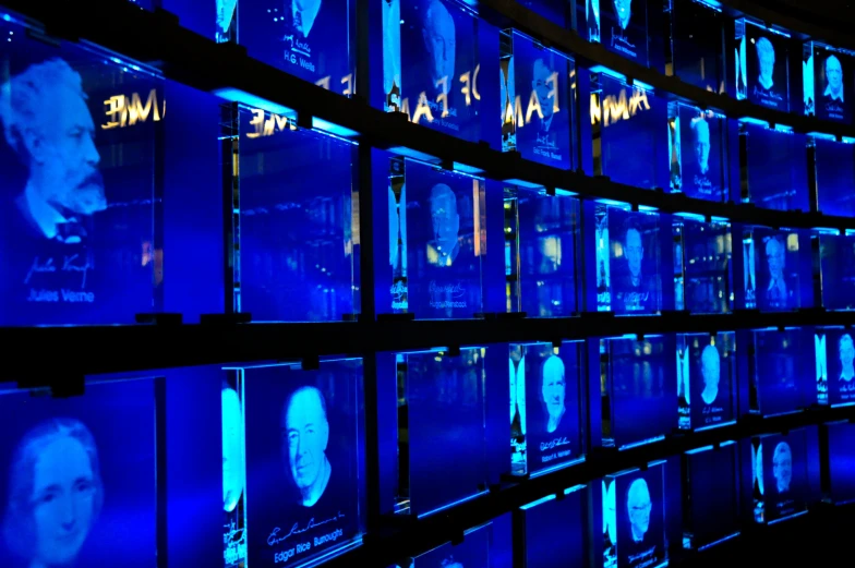 several rows of illuminated blue lighted displays of famous movies