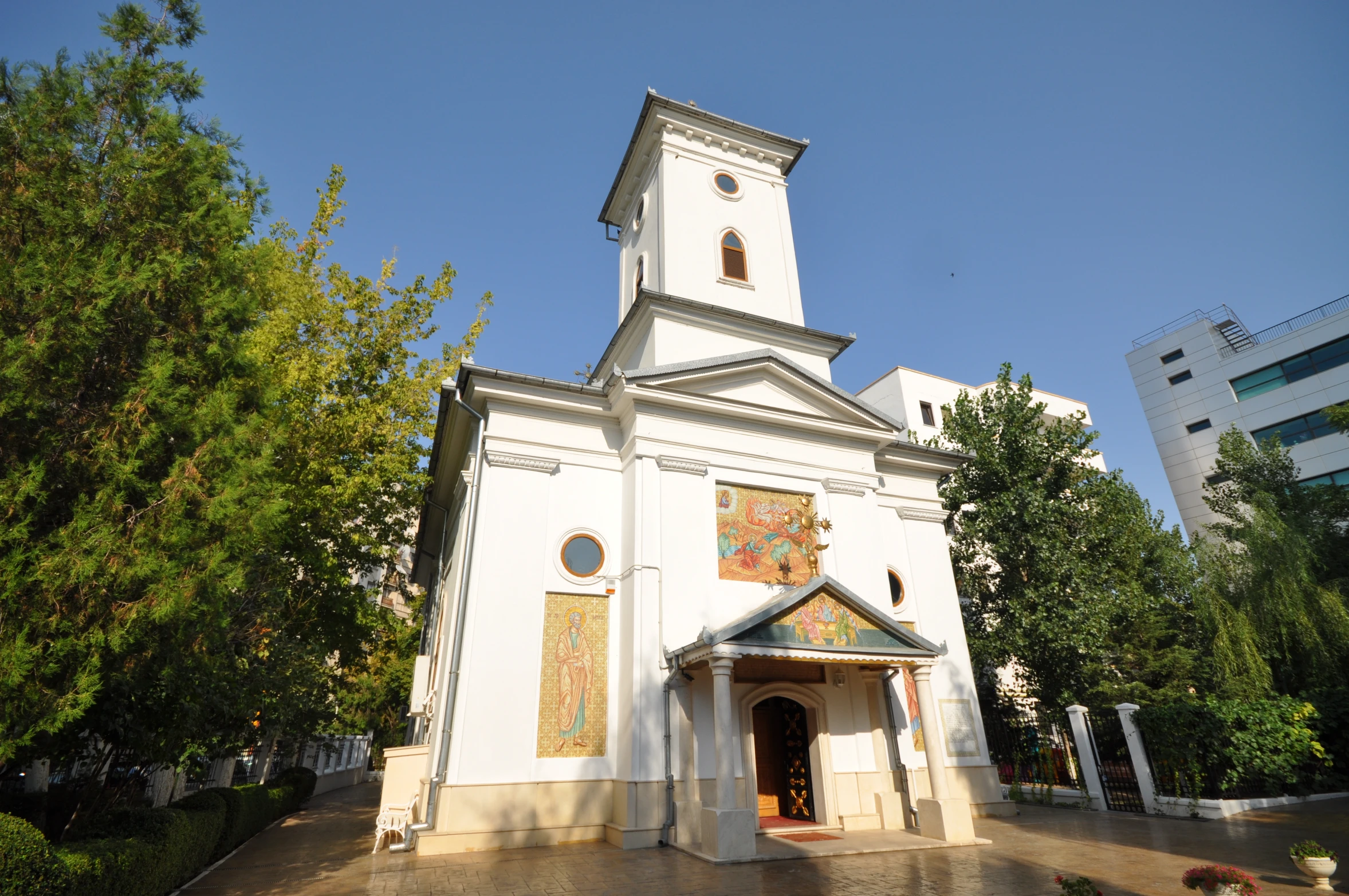 this church is white and has murals on it