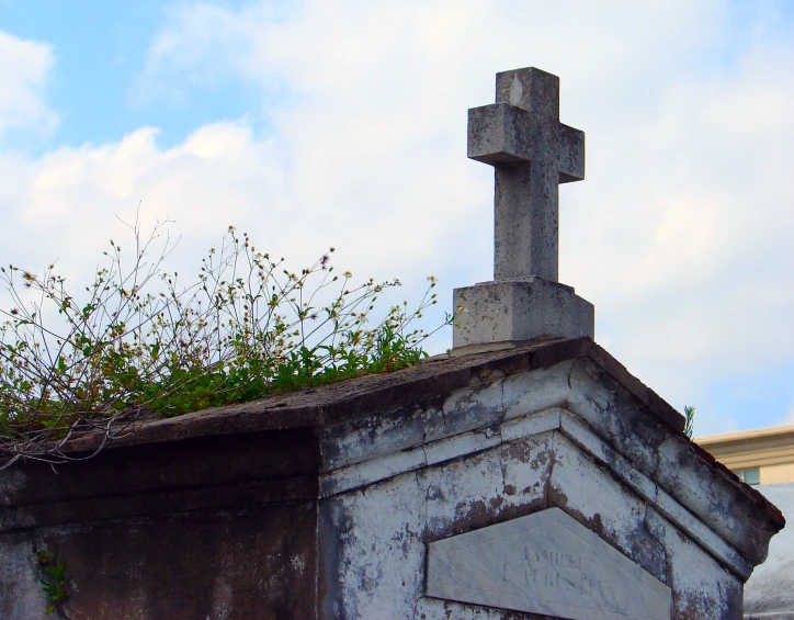 an outdoor cross on top of a grave