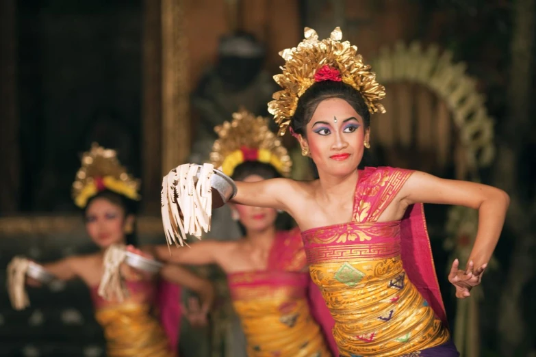 the woman in the yellow dress is singing with others behind her