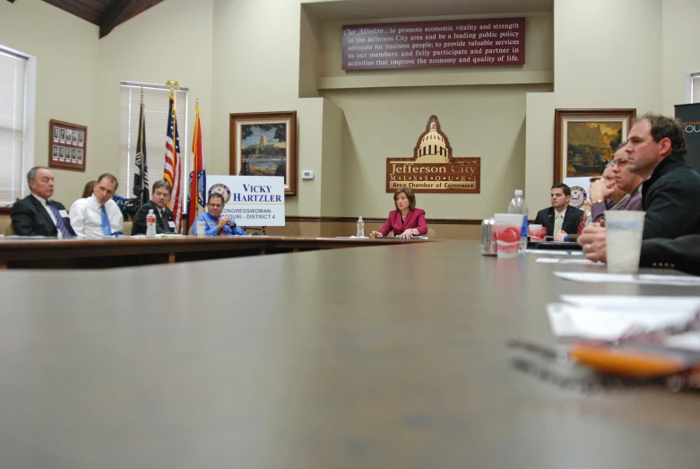 a group of people are sitting at a table