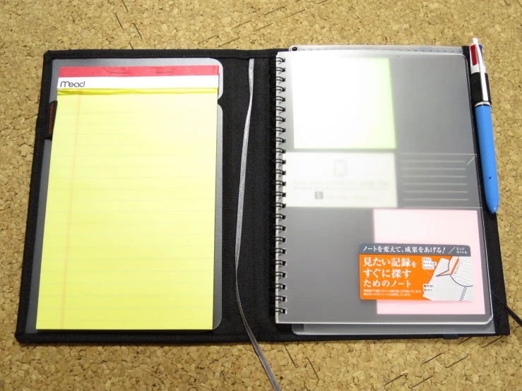 a notepad with a pen and a blank pad attached to it