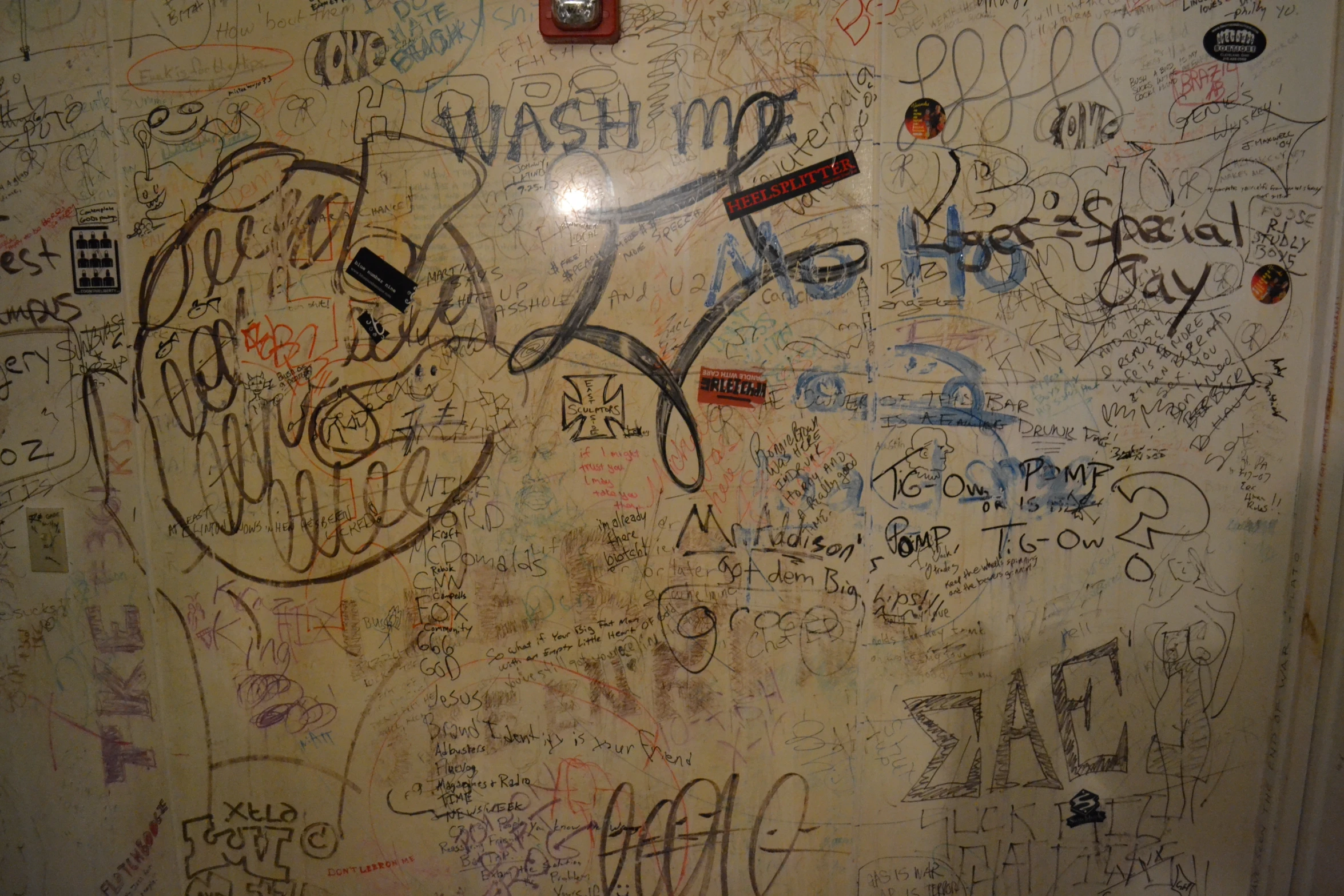 a very old wall covered with graffiti that has been cleaned