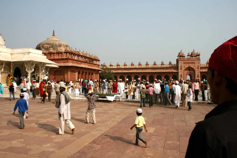 a number of people standing near a building