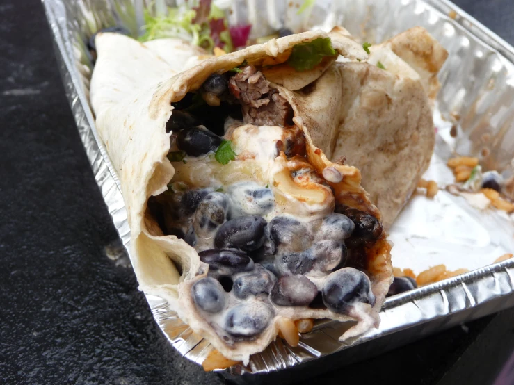 an image of a burrito in a foil container