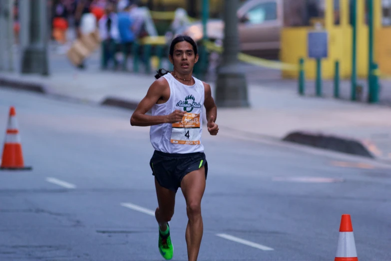 a man running on the street with a green shoe