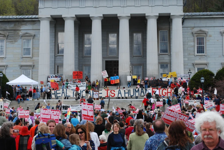 a large group of people standing outside of a building