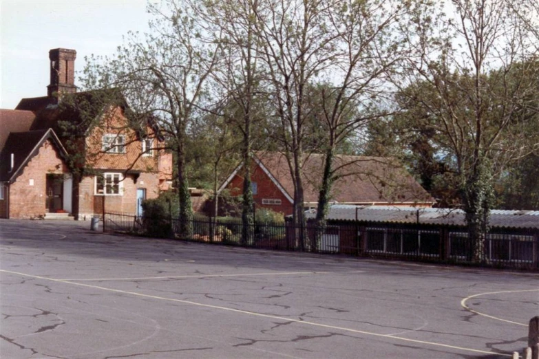 a residential area with a basketball court and parking lot