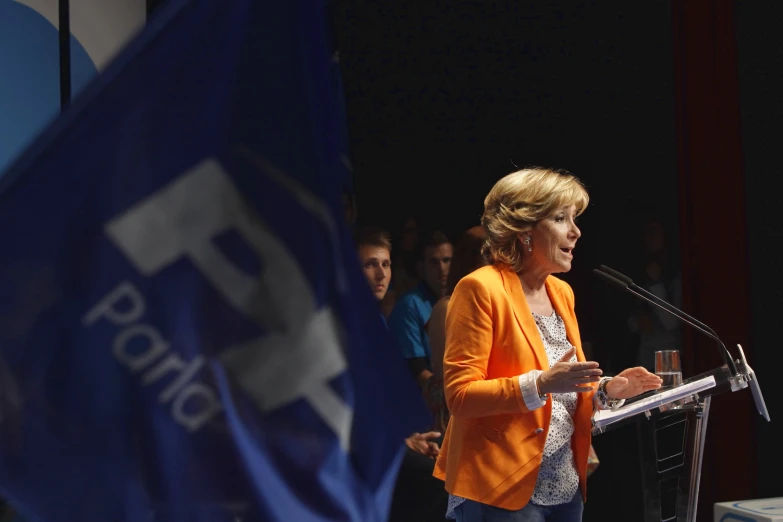 a woman giving a speech at an event