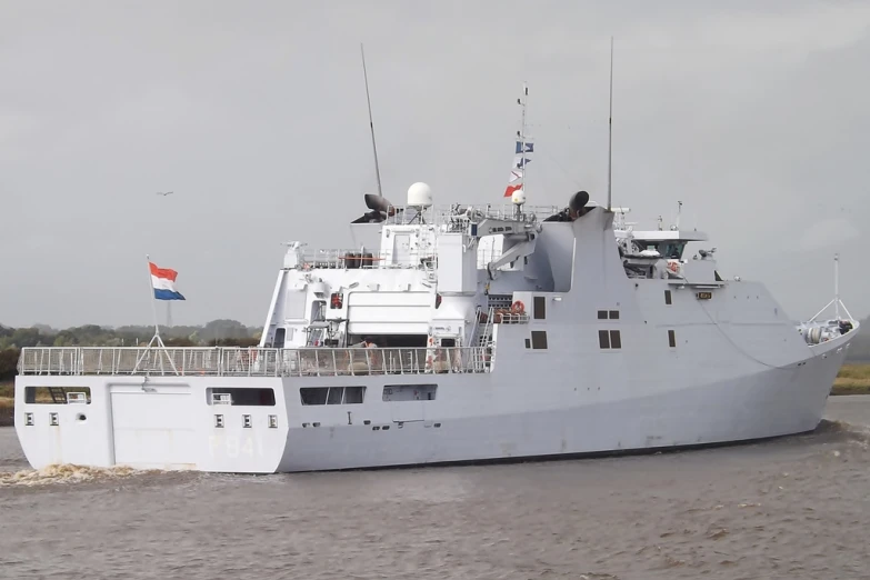 a large white ship sailing down a river