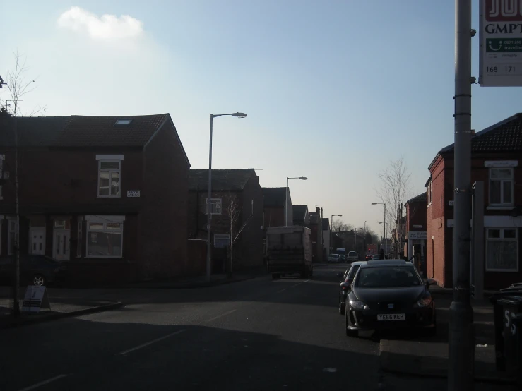 an image of a street that has houses and a car