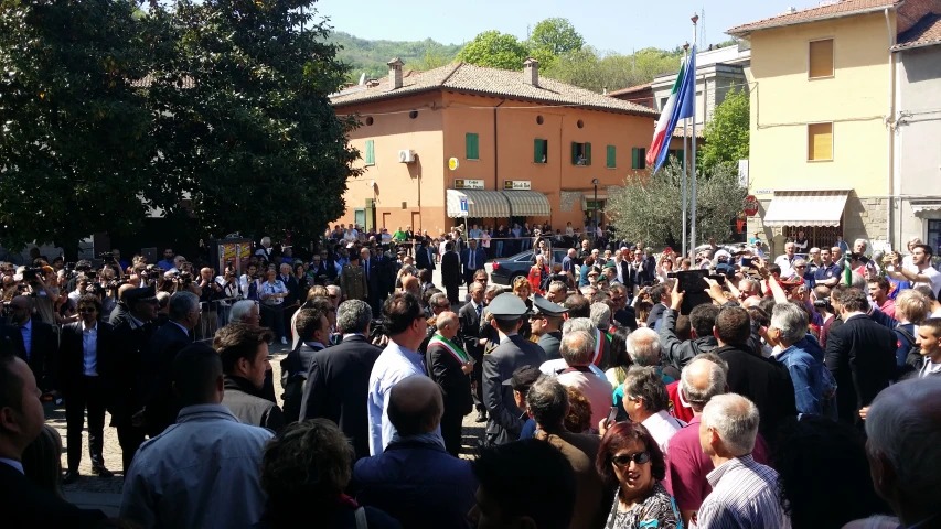 a large crowd of people standing outside of buildings