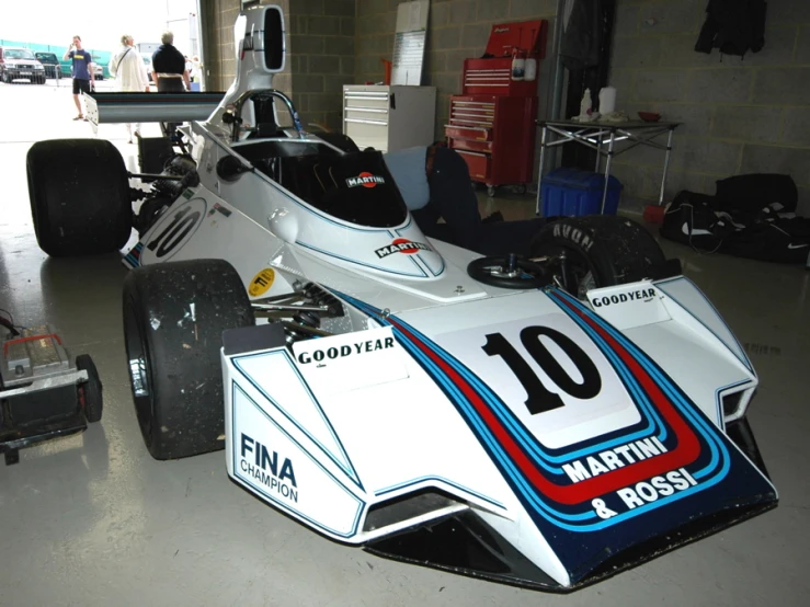 a formula car being displayed in a race shop