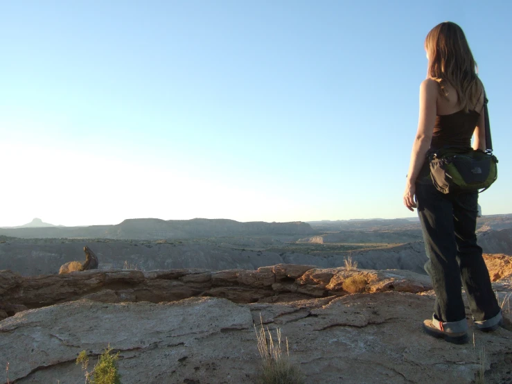 woman standing on a rocky cliff enjoying the view