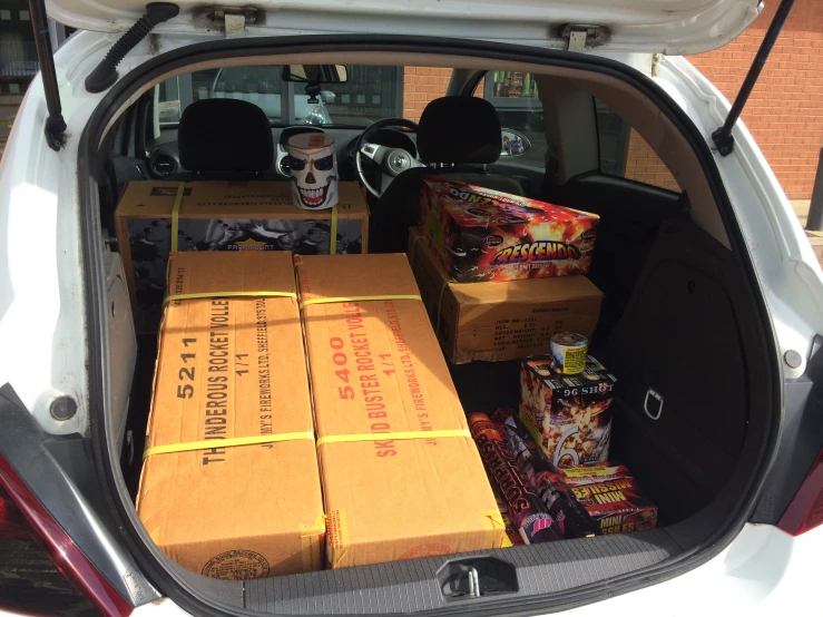 the trunk of a car loaded with boxes of food