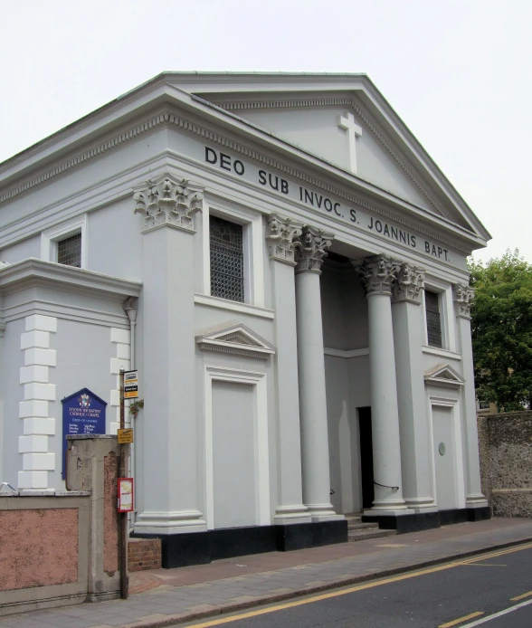 a large building with a sidewalk below it