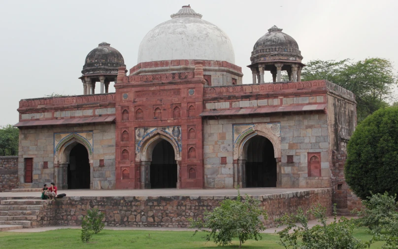 a red and white building with many arches