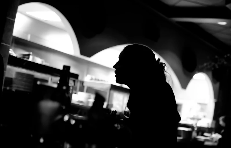 the silhouette of a woman in a restaurant