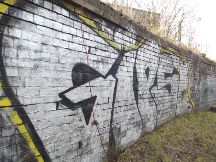 graffiti on a brick wall with an arrow pointing upwards