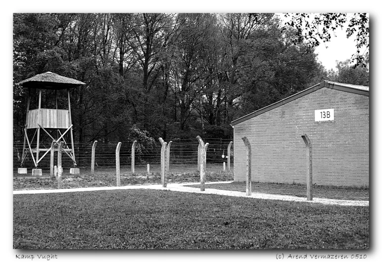 a wooden fence and a buoy tower in a back yard