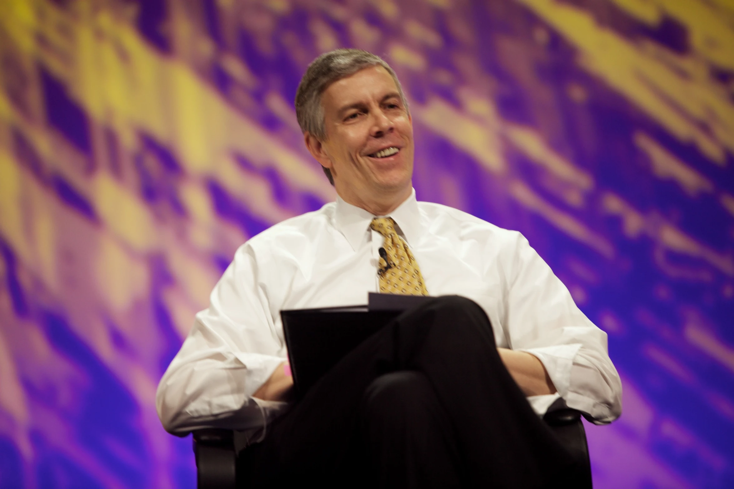 an old man wearing a yellow tie and white shirt