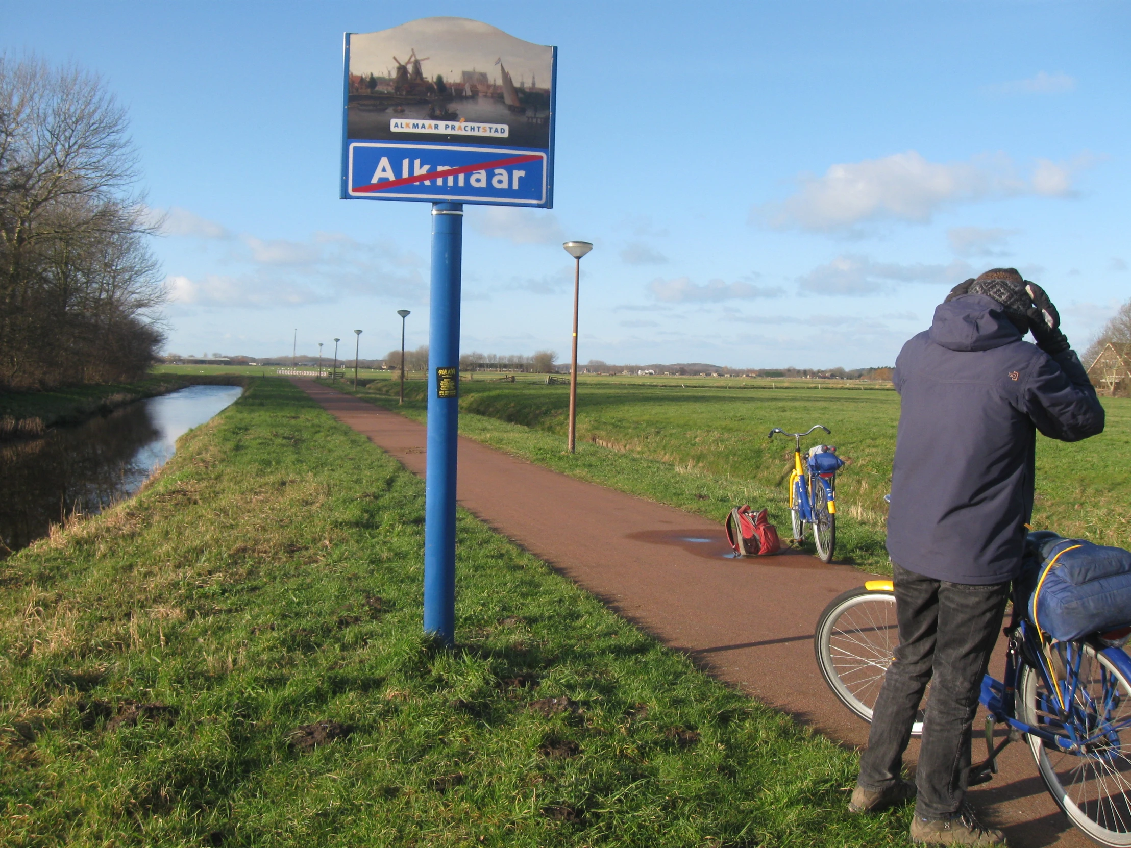 a man standing on a sidewalk near a bike