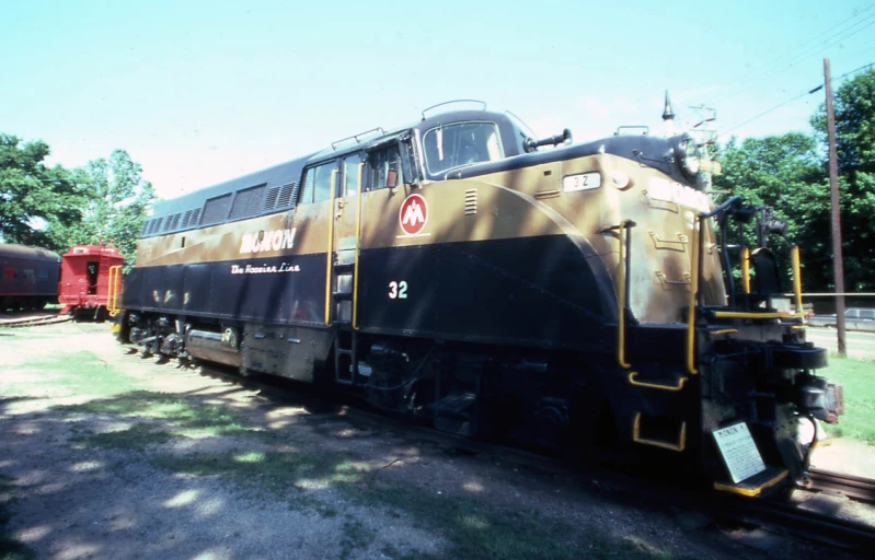 two train cars on tracks in an empty yard