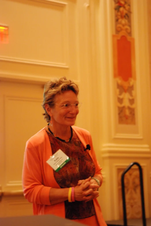 woman smiling while standing in an ornately decorated room