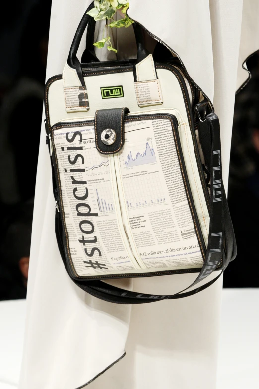 a handbag is shown with newspaper printed fabric