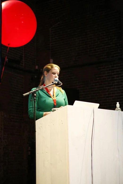 a woman standing at a podium and speaking