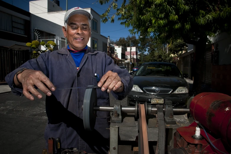 an old man standing by some vehicles outside