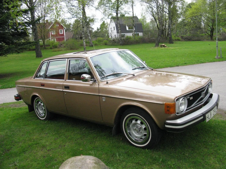 a brown car parked on top of green grass