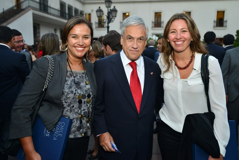 three business people smile and stand for a picture