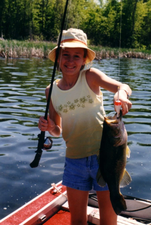 a woman with a fish is holding up the fish